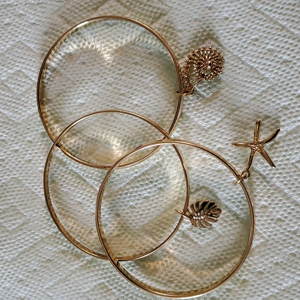 3pc Gold tone shell, leaf, and star bangle charm bracelets.